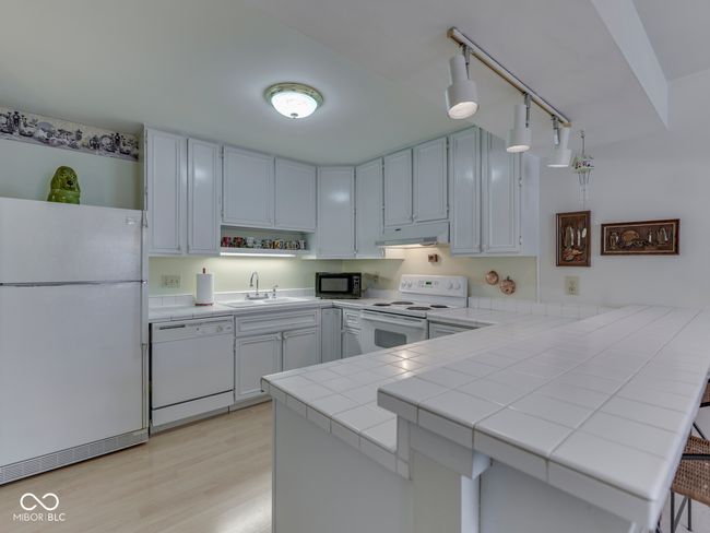Bright kitchen with tile countertops | Image 16