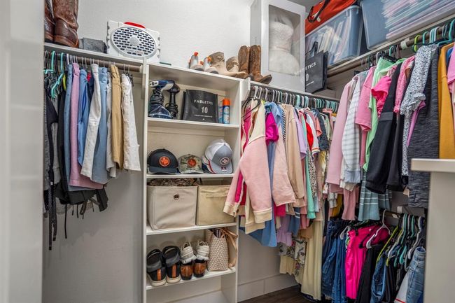 Step inside the spacious walk-in closet, thoughtfully designed with built-in shelves and ample hanging space — everything you need to keep your wardrobe organized and easy to access. | Image 22