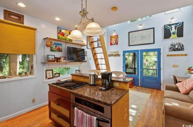 Kitchen featuring stainless steel oven, light wood-style flooring, and a healthy amount of sunlight | Image 5