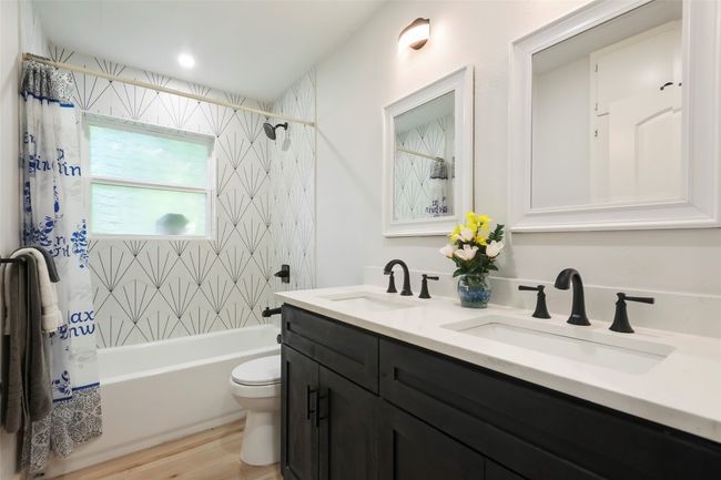 Dual vanities in hall bedroom separates Primary bedroom from rest of bedrooms | Image 17
