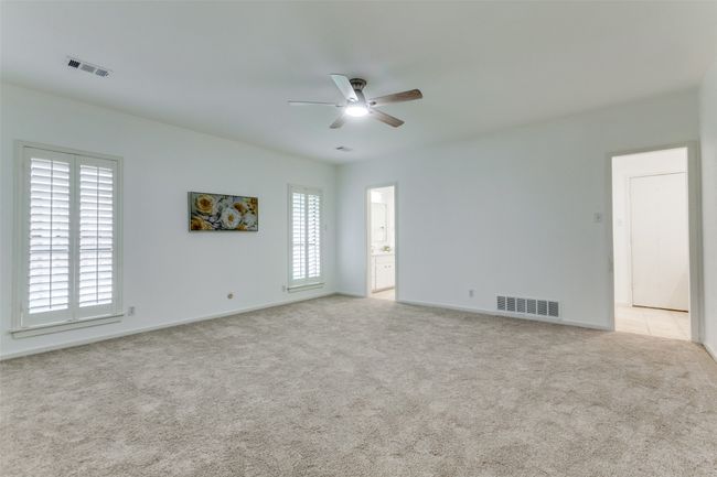 The large master bedroom has two entrances into the separate vanity areas. | Image 18