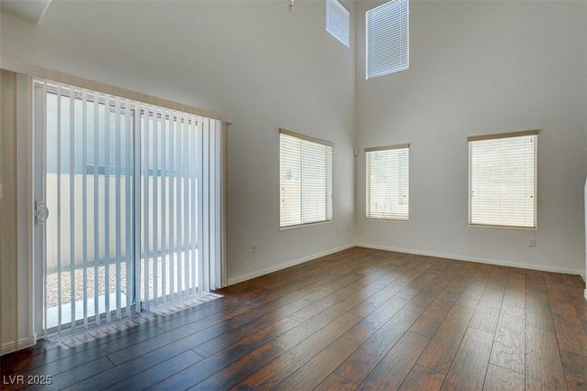 Unfurnished room featuring a healthy amount of sunlight, baseboards, and wood-type flooring | Image 6