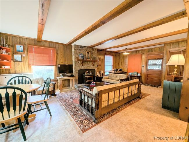 Den w/ exposed beams & wood-burning stone fireplace | Image 24