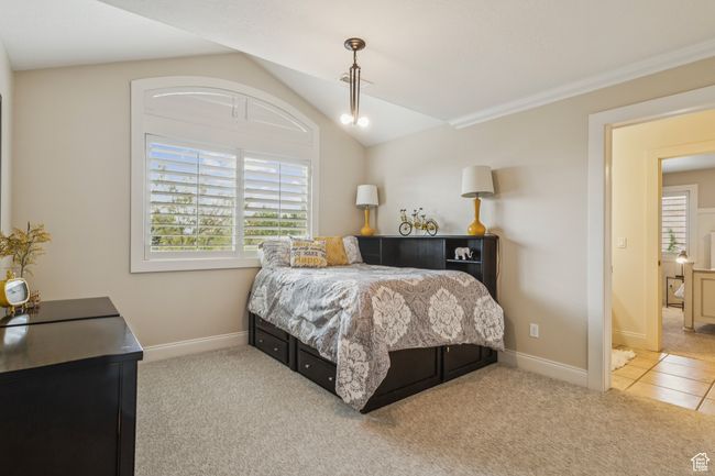Carpeted bedroom featuring lofted ceiling and baseboards | Image 41
