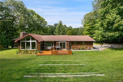 Single story home with a front lawn and a deck | Image 3