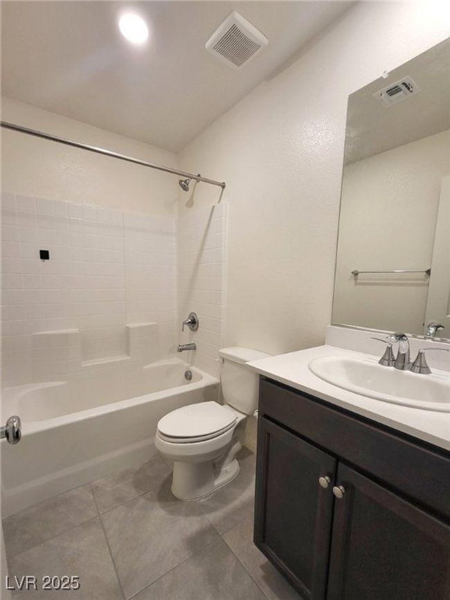 Full bath with shower combination, visible vents, toilet, and vanity | Image 6