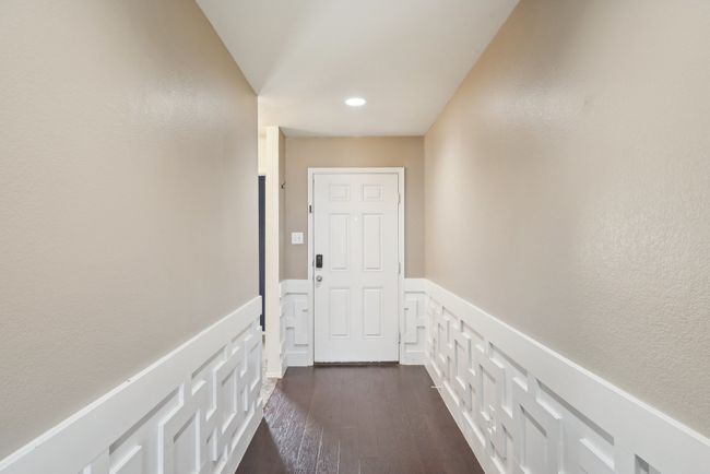 Corridor featuring dark wood finished floors, a decorative wall, recessed lighting, and a wainscoted wall | Image 14