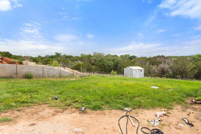 Large backyard with storage building, backs up to animal sanctuary for beautiful views | Image 9