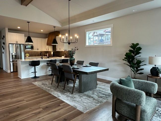 Dining space with a chandelier, dark wood-style floors, and recessed lighting | Image 7