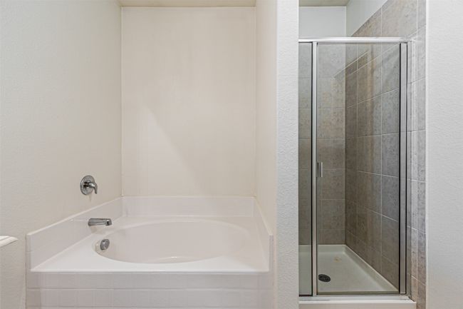Bathroom featuring a shower stall and a bath | Image 20