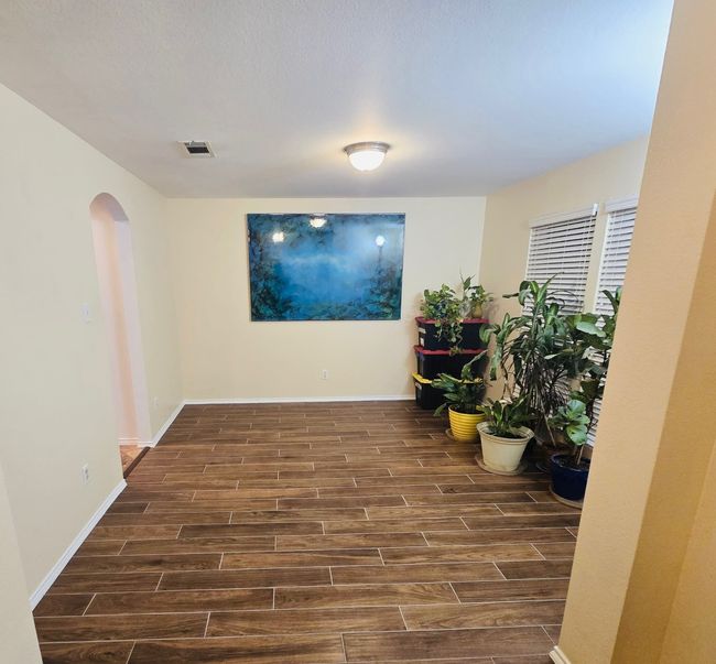 Hallway with wood finished floors and arched walkways | Image 24
