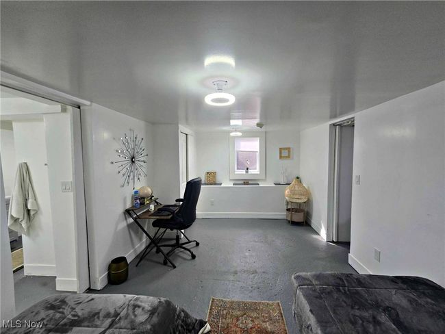 Bedroom with baseboards and concrete flooring | Image 47