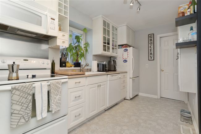 The white cabinets on the right act as a pantry, and the door at the back opens to the first floor full bathroom (which is also accessible via the first floor bedroom). | Image 11