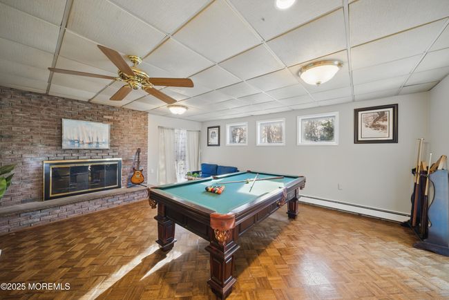 1st floor spacious living room with hw floors, fireplace, kitchenette nearby with sliders to level yard | Image 37