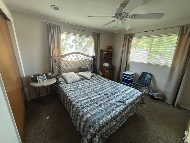 Carpeted bedroom with multiple windows, a ceiling fan, and baseboards | Image 14