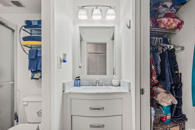 Bathroom featuring toilet and a shower | Image 16