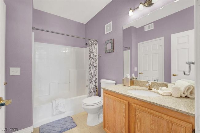Bathroom featuring shower / bath combo, visible vents, toilet, and tile patterned flooring | Image 28