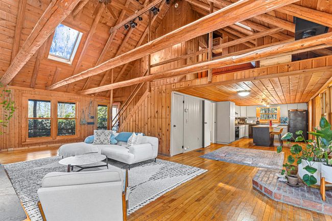 Living area featuring wood ceiling, hardwood / wood-style flooring, wood walls, and beamed ceiling | Image 12