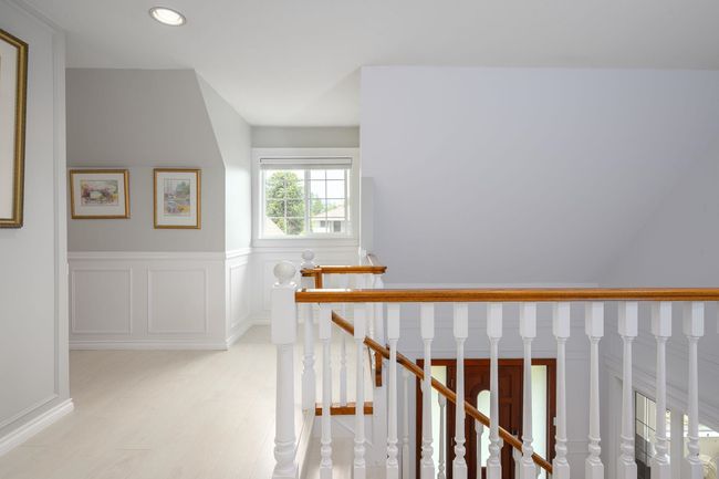 Hallway with an upstairs landing, light wood-style floors, recessed lighting, and wainscoting | Image 14
