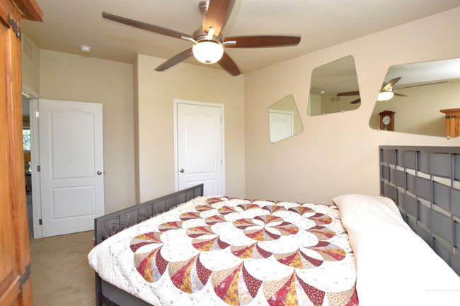Carpeted bedroom featuring ceiling fan | Image 20