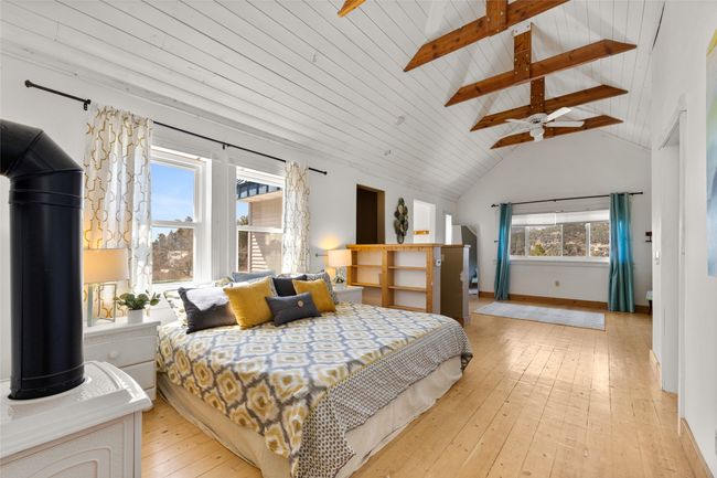 Bedroom featuring vaulted ceiling with beams, and light wood-style flooring | Image 18
