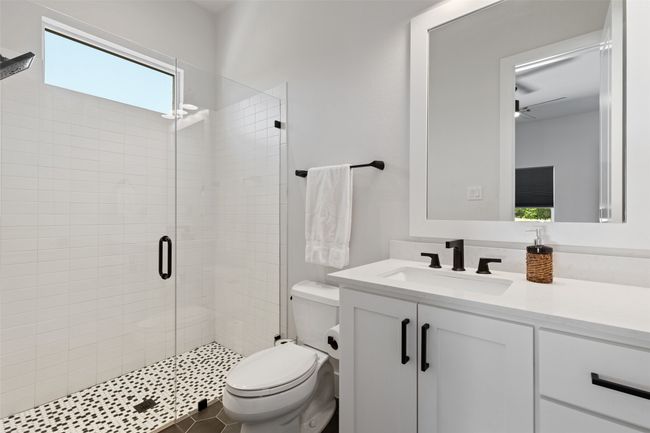 Full bathroom with toilet, a stall shower, and vanity | Image 24