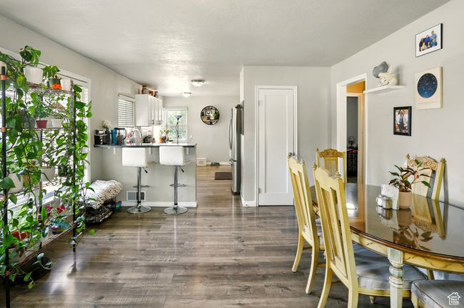 Dining area featuring wood finished floors and baseboards | Image 5