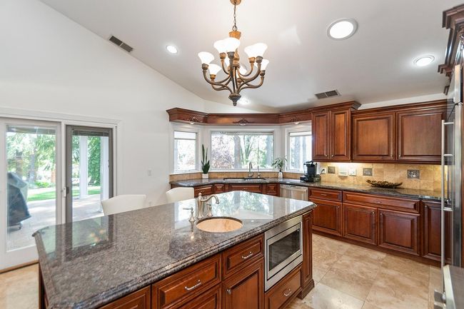 High ceiling and Pella slider to back covered patio, perfect for winter BBQ's! | Image 22