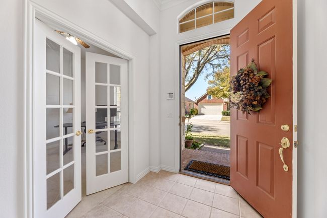 Tiled foyer entrance with ceiling fan, a healthy amount of sunlight, ornamental molding, and french doors | Image 6