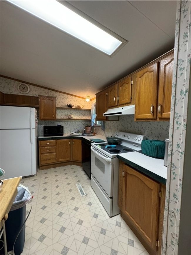 This kitchen has a very nice size pantry and lots of counter space. The wrap-around island provides even more counter space. | Image 13