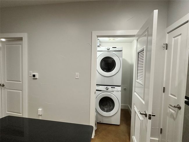 Laundry room featuring stacked washer / drying machine | Image 16