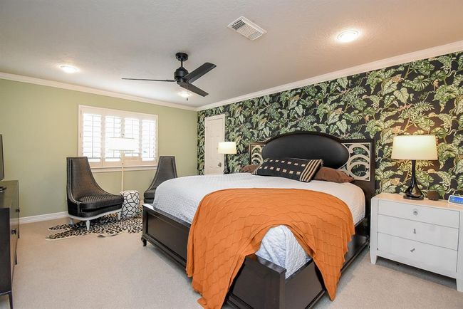 This large secondary bedroom, measures approximately 16' x 12'. It features a remodled private ensuite bath, and walk in closet. | Image 35