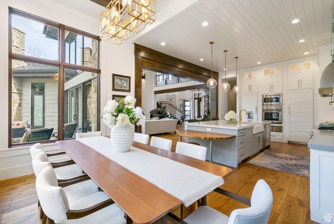 Dining area featuring an inviting chandelier, recessed lighting, wood ceiling, and hardwood / wood-style floors | Image 32