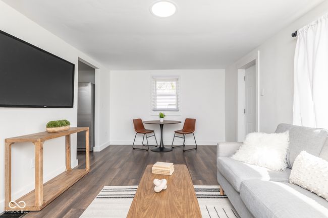 living room with wood finished floors and baseboards | Image 7