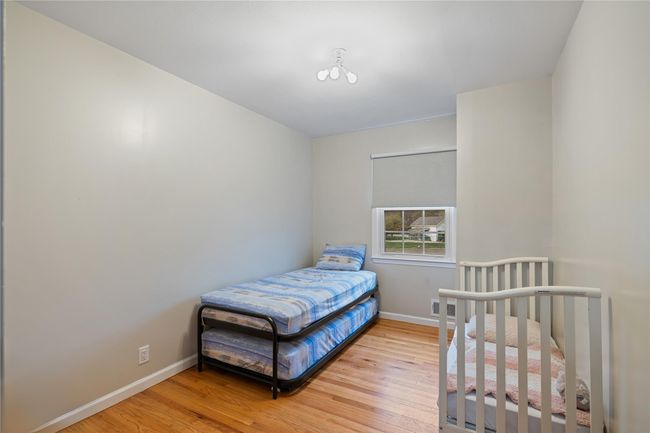 Bedroom featuring wood finished floors and baseboards | Image 24