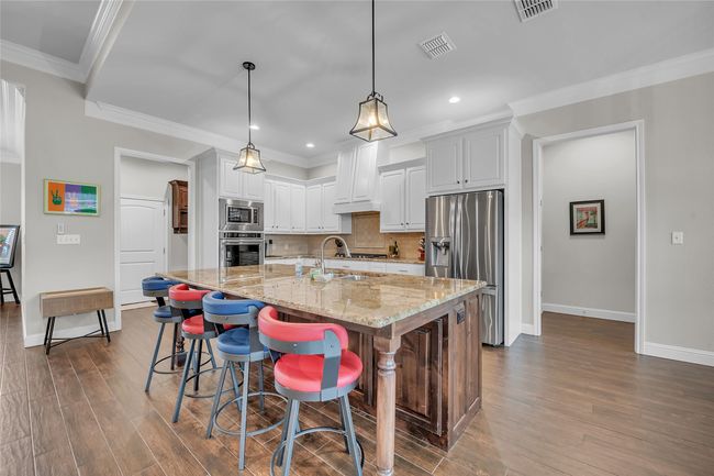 Kitchen with appliances with stainless steel finishes, a sink, dark wood-style flooring, baseboards, and recessed lighting | Image 14