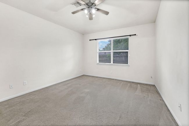 The large primary bedroom has a big window overlooking the backyard. The room offers a clean, neutral space ready for you to make it your own! | Image 16