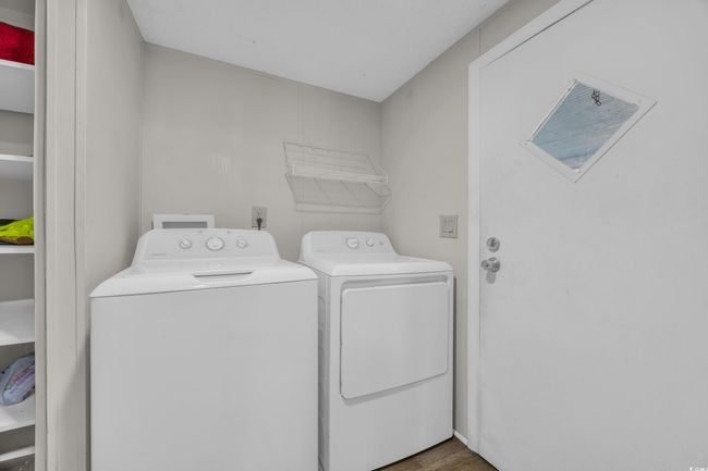 Laundry room featuring washer and dryer and wood finished floors | Image 20