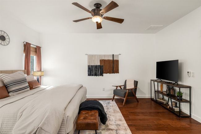 Bedroom with dark wood-style flooring and a ceiling fan | Image 15