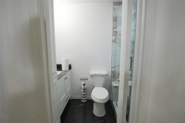 Full bath with vanity, toilet, a shower, and tile patterned floors | Image 9