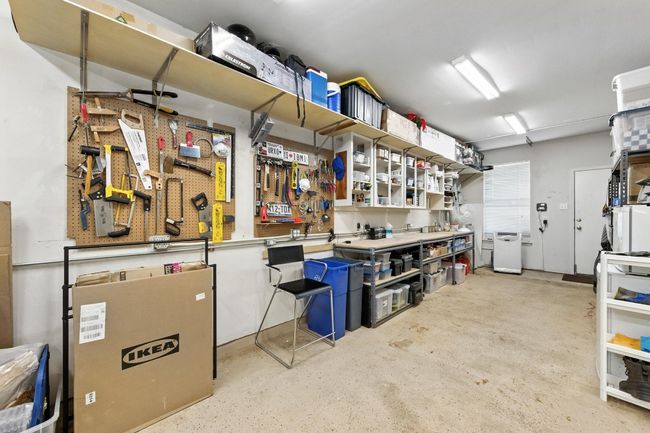 Garage featuring a workshop area | Image 29
