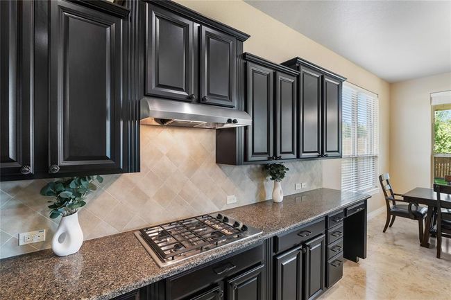 Exquisite blend of colors and materials in the stunning kitchen. | Image 11