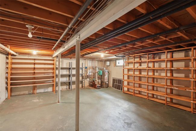 Below grade area featuring water heater | Image 33