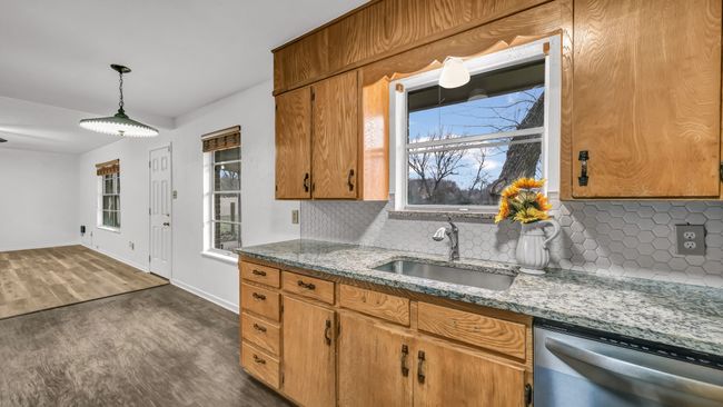 Kitchen with pendant lighting looking out to the expansive back yard. | Image 16