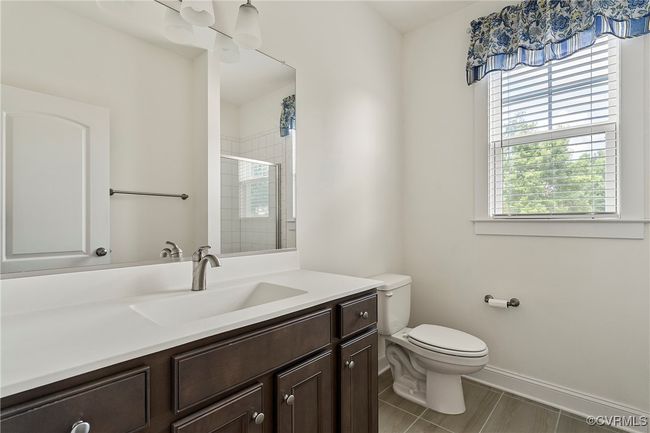 Bathroom featuring a shower stall and vanity | Image 21