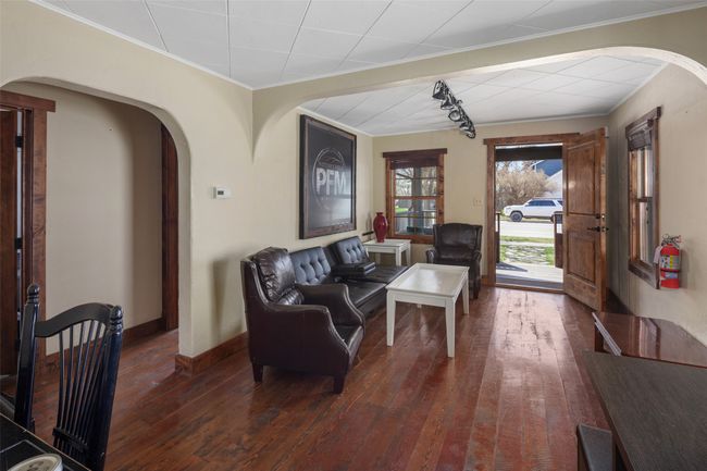 Living room with hardwood / wood-style floors, arched walkways, and crown molding | Image 11