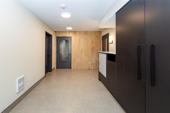 Tiled floors and accent walls punctuate the crisp modern feel of the brand new building. | Image 4