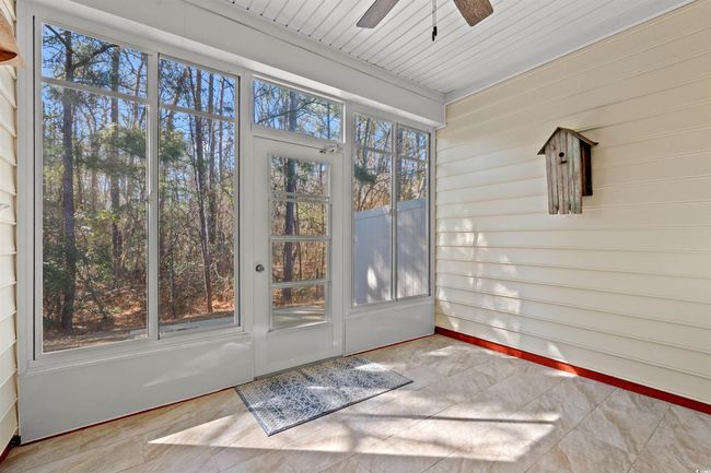 Unfurnished sunroom featuring a ceiling fan | Image 22