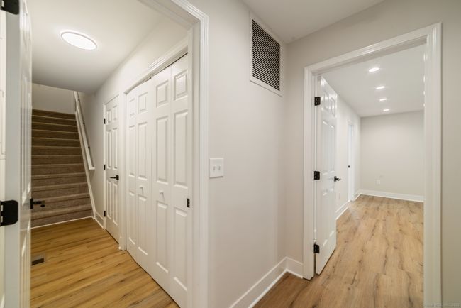 The stairs in the utility area lead to the attached garage. This area also houses the brand-new washing machine and dryer, which have integrated wi-fi, allowing you to control them away from home directly from your smartphone. The dryer also has a st | Image 27
