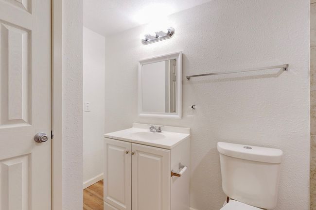 Bathroom with vanity, wood-type flooring, and toilet | Image 23